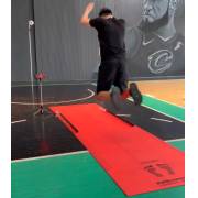 Athlete mid jump over the long jump mat