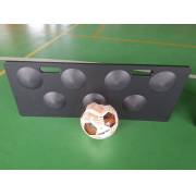 Black rebound board with round dimples and two hand slots, a ball in front