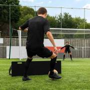 Supplier photo of a player shaping to strike the ball into the board, with a goalkeeper waiting in goal