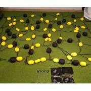 Close view of the rebound net grid with yellow and black foam balls in three sizes