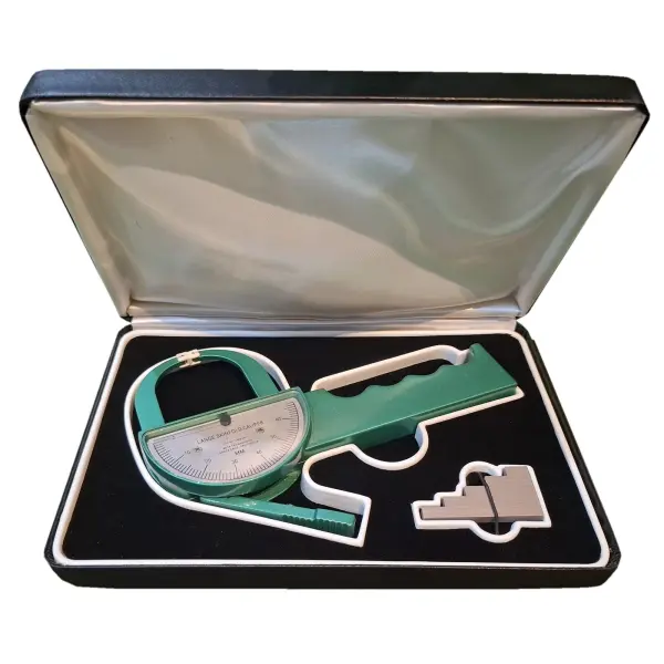 Lange skinfold caliper in its open case with the calibration block, on a white background
