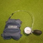The clear tube running from the pad to the gauge and hand bulb